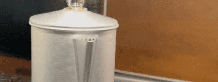 Metal pitcher on a kitchen countertop.